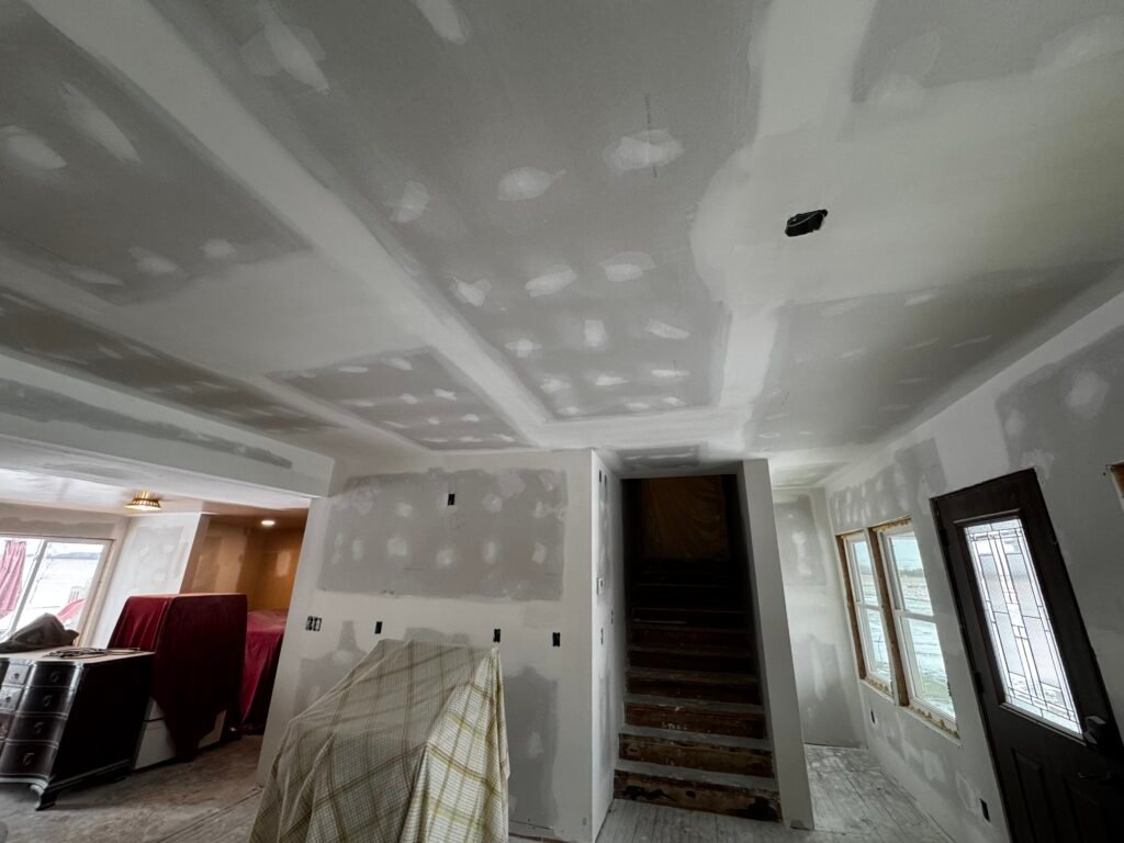 Patched and sanded drywall ceiling with recessed lighting in a living room