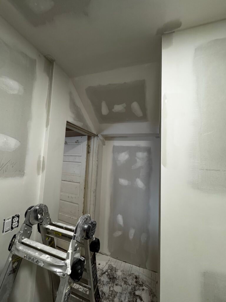 Interior drywall finishing in a hallway