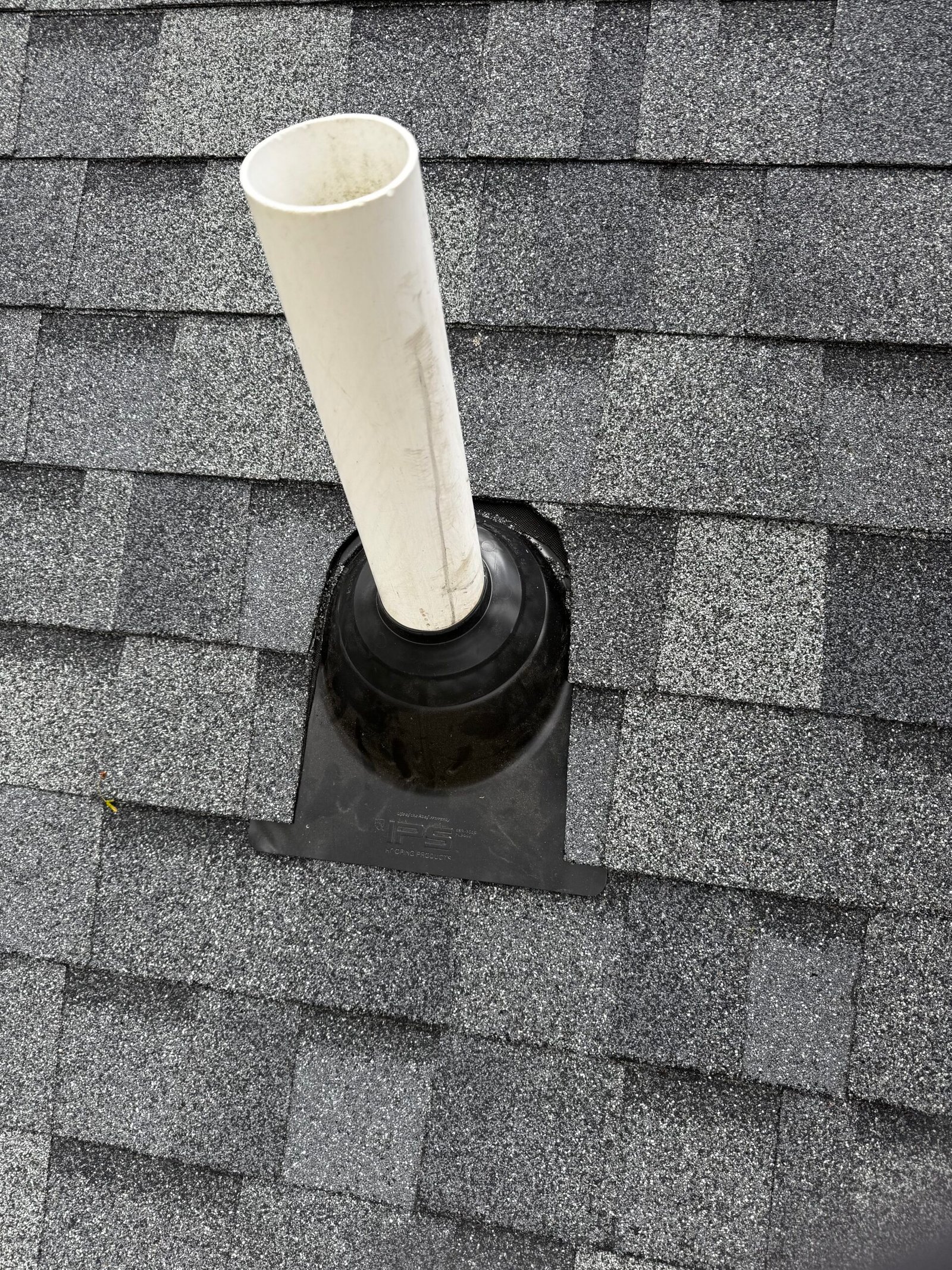 Roof vent pipe with flashing on an asphalt shingle roof