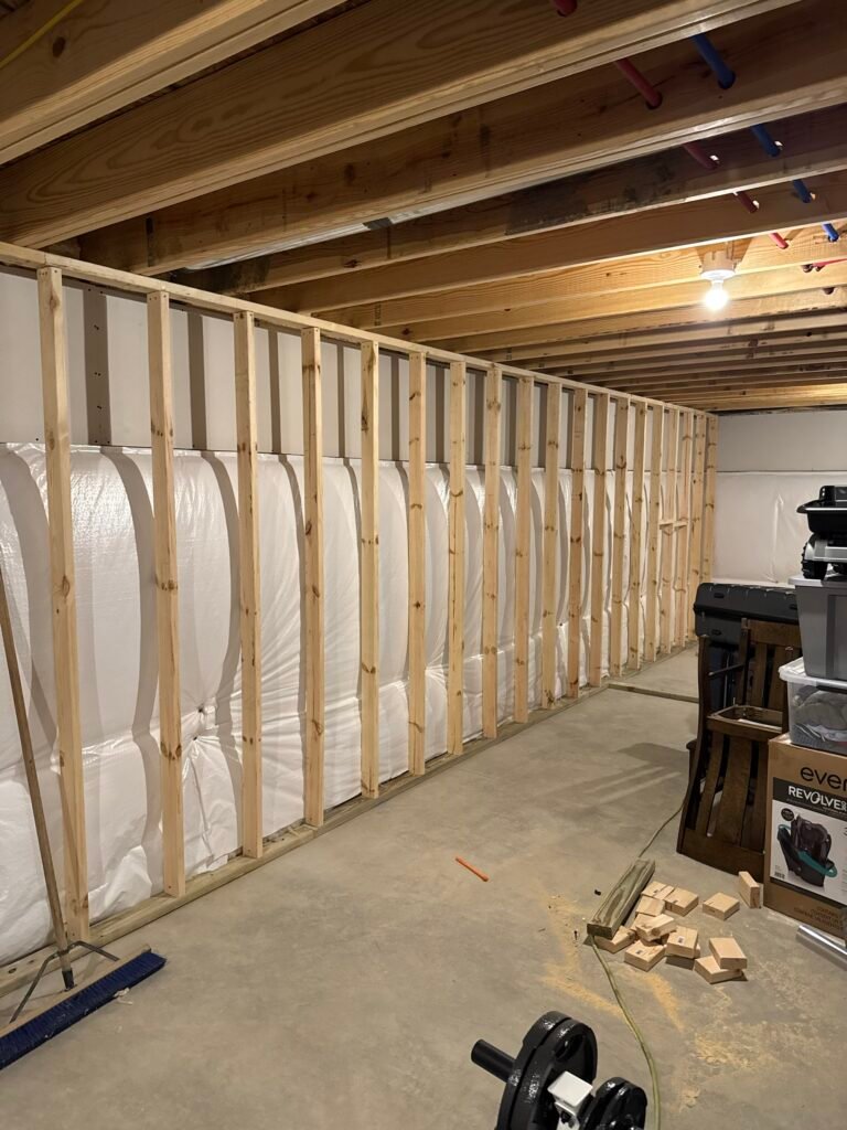 New stud wall framed along the insulated foundation wall